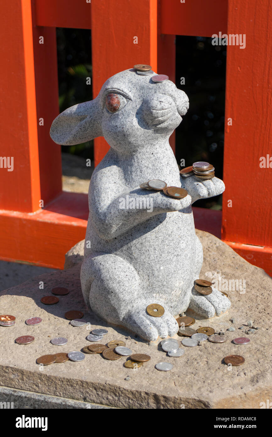 Miyazaki, Japan November 6, 2018 Stone rabbit statue with some coins
