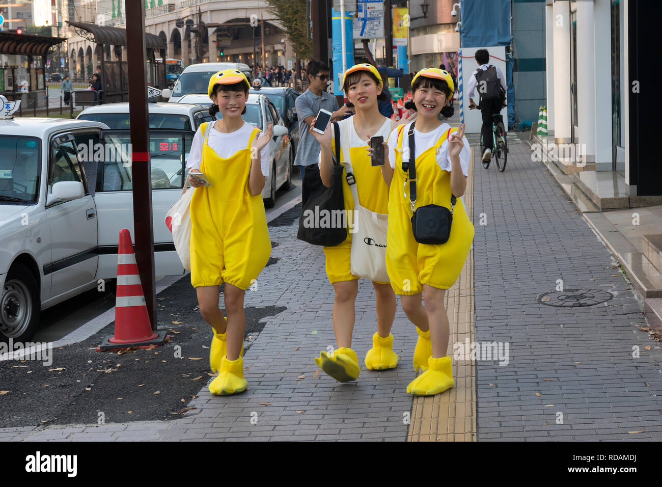 Kumamoto, Japan - November 10, 2018:Japanese teenage girls dressed like chickens making fun in the shopping street Stock Photo