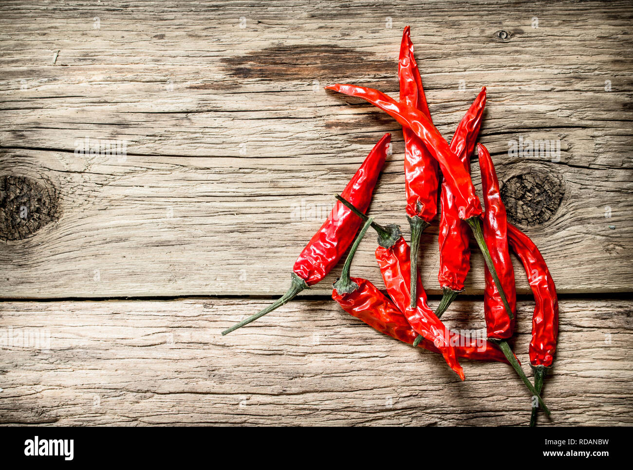 Hot chili peppers . On wooden background Stock Photo - Alamy