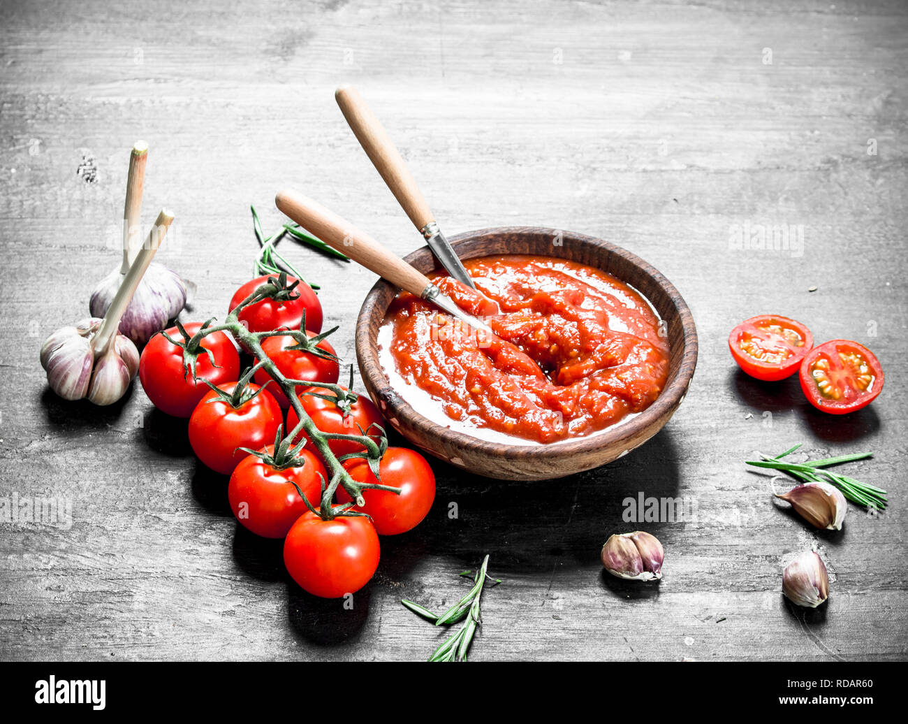 Tomato sauce with garlic and herbs. On black background Stock Photo Alamy