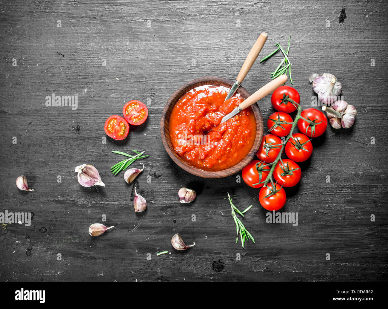 Tomato sauce with garlic and herbs. On black background Stock Photo Alamy