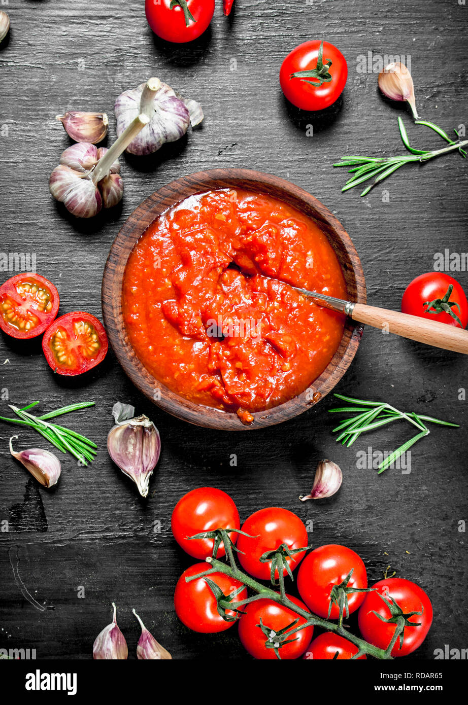 Tomato sauce with garlic and herbs. On black background Stock Photo Alamy