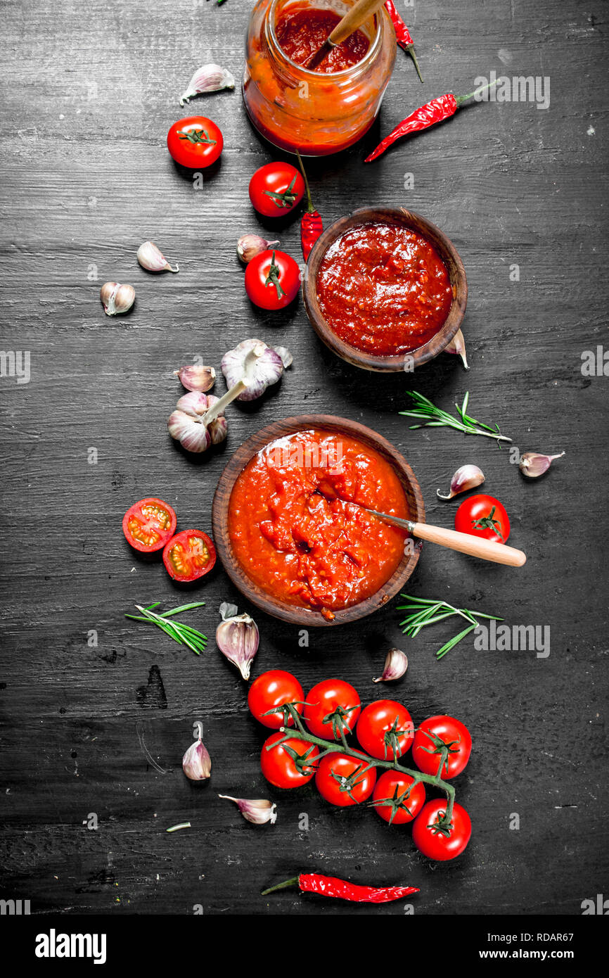 Tomato sauce with garlic and herbs. On black background Stock Photo Alamy