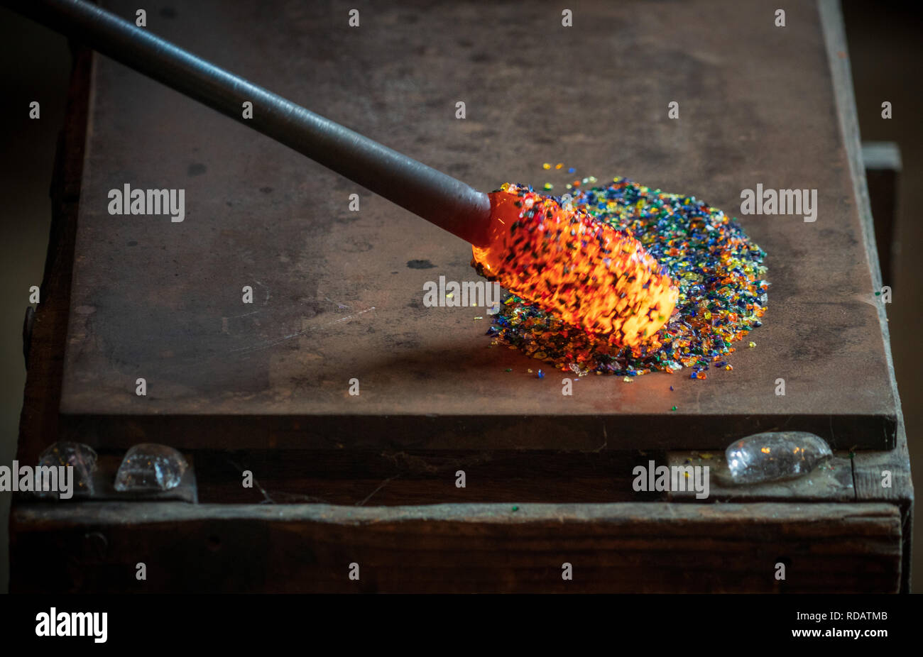 A glass blowing artist forms a blob of glass into a vessel using a gas torch  in Vermont Stock Photo - Alamy