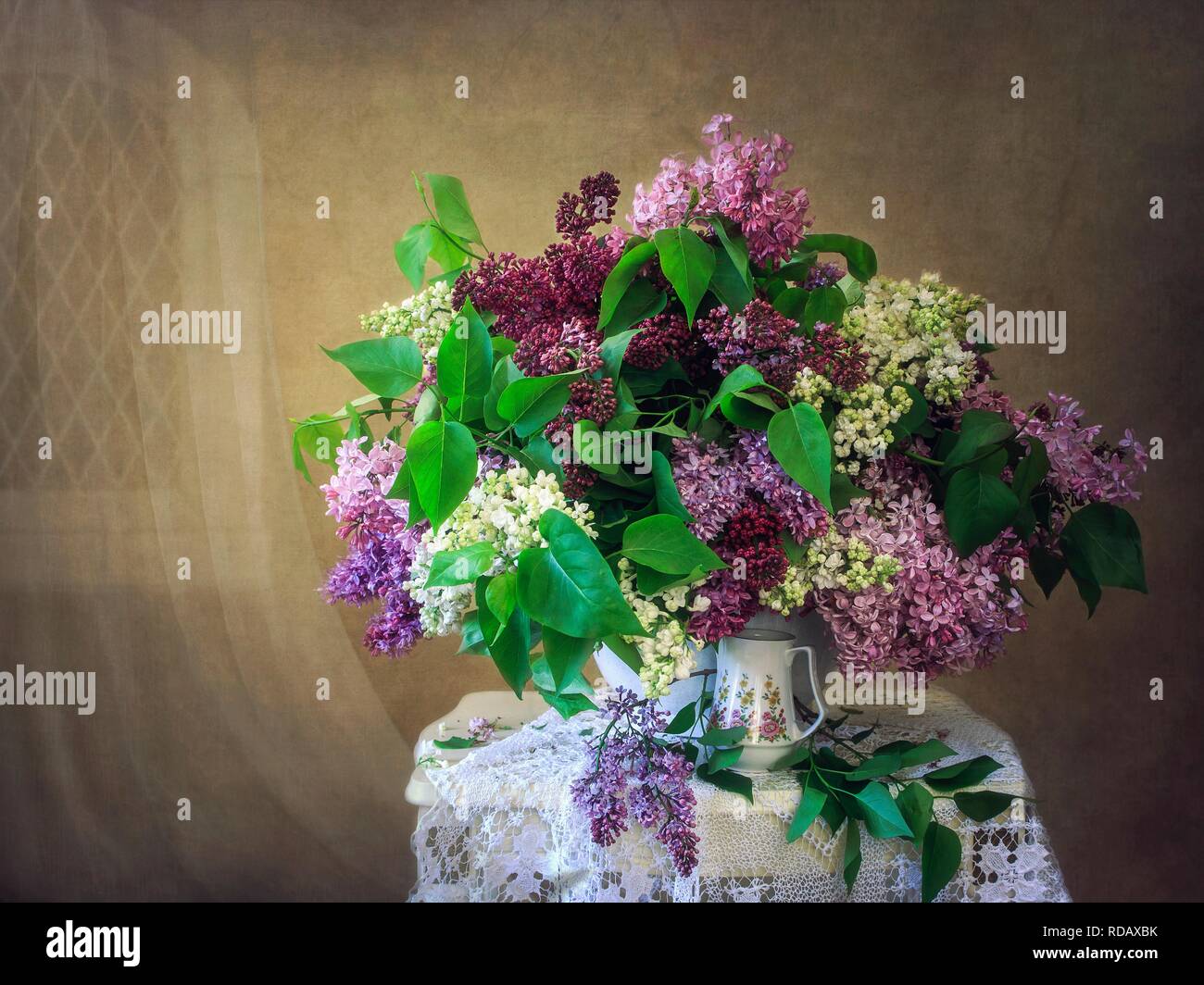 Still life with bouquet of multicolored lilac Stock Photo - Alamy