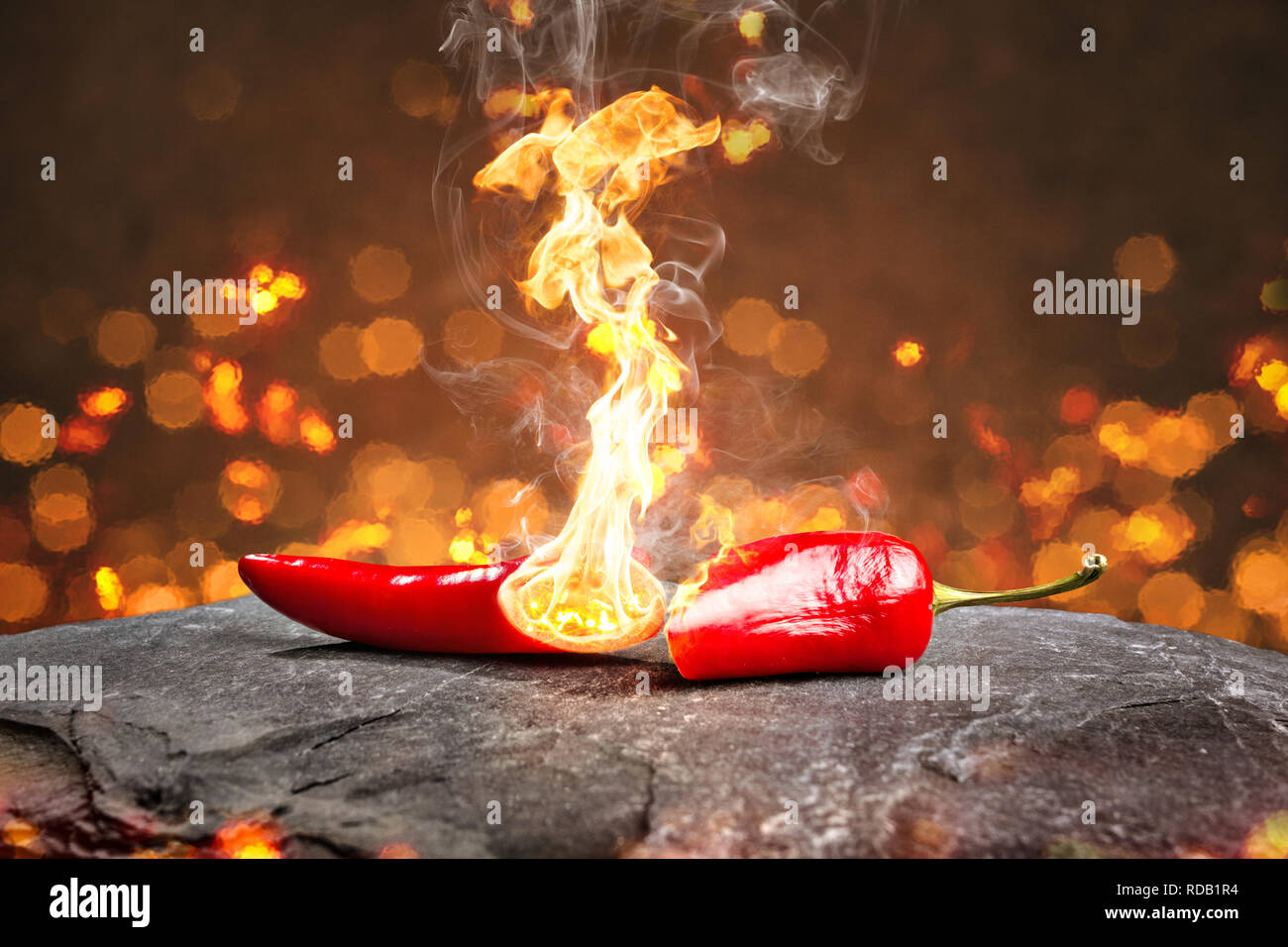 Burning hot chili pepper with a flame Stock Photo