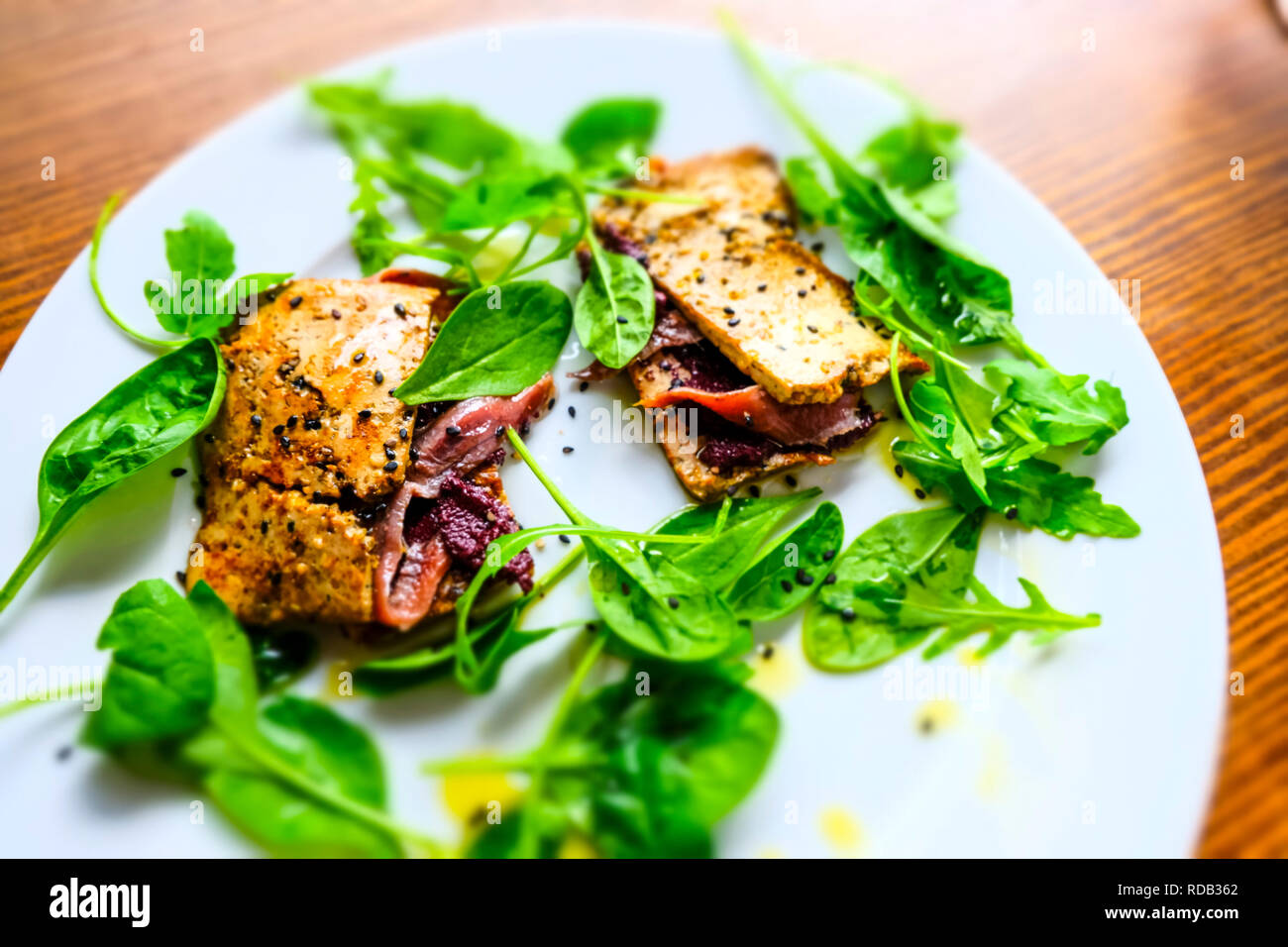 Tofu with anchovies, olive pate and corn salad. Stock Photo