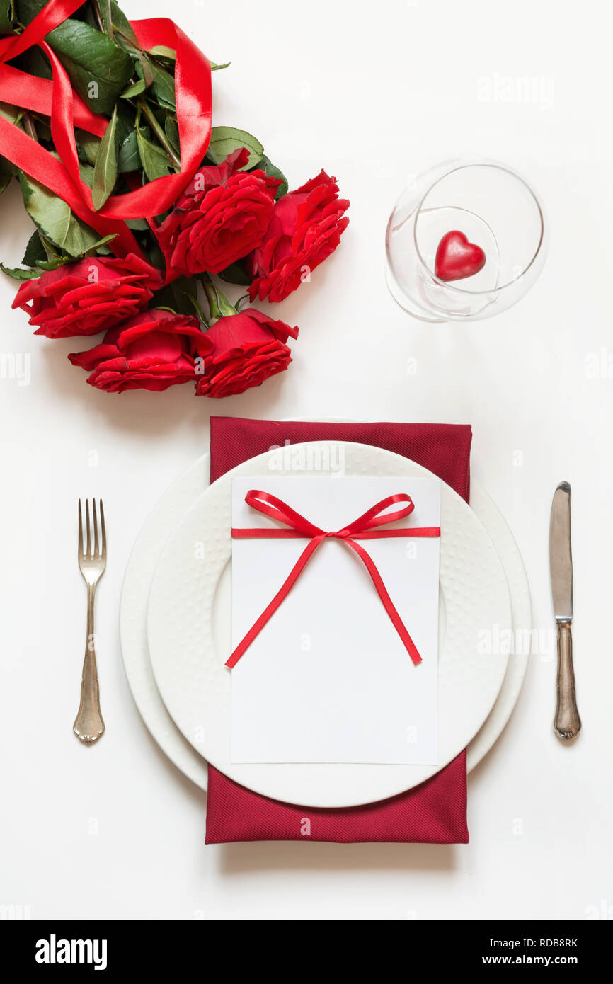 Valentine's day dinner. Romantic table setting with red roses. Top view ...