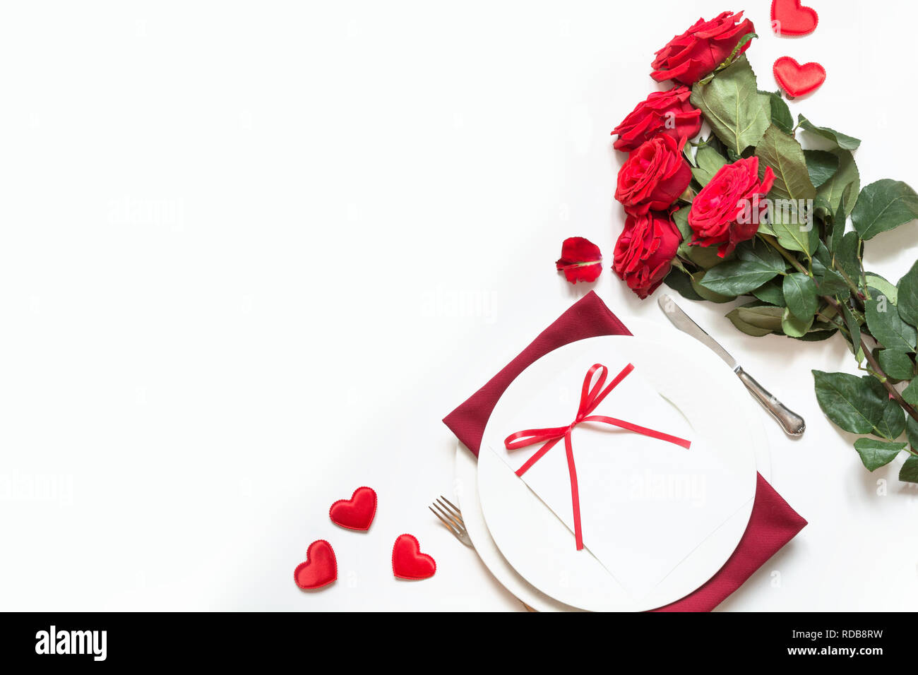 Valentine's day dinner. Romantic table setting with red roses. Top view ...
