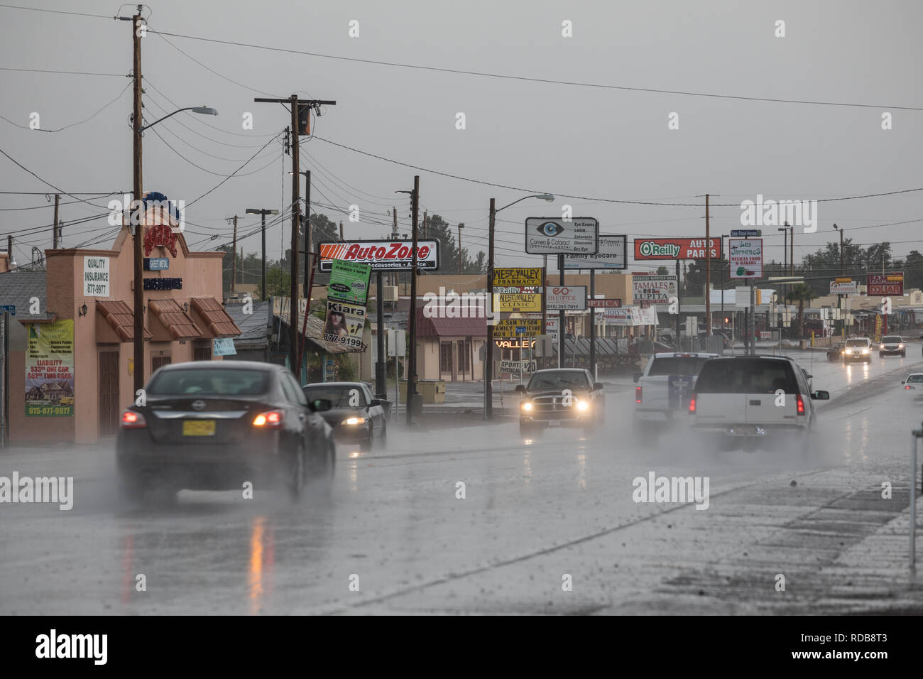 Cars drive through large puddles as heavy rain hits the El Paso Upper