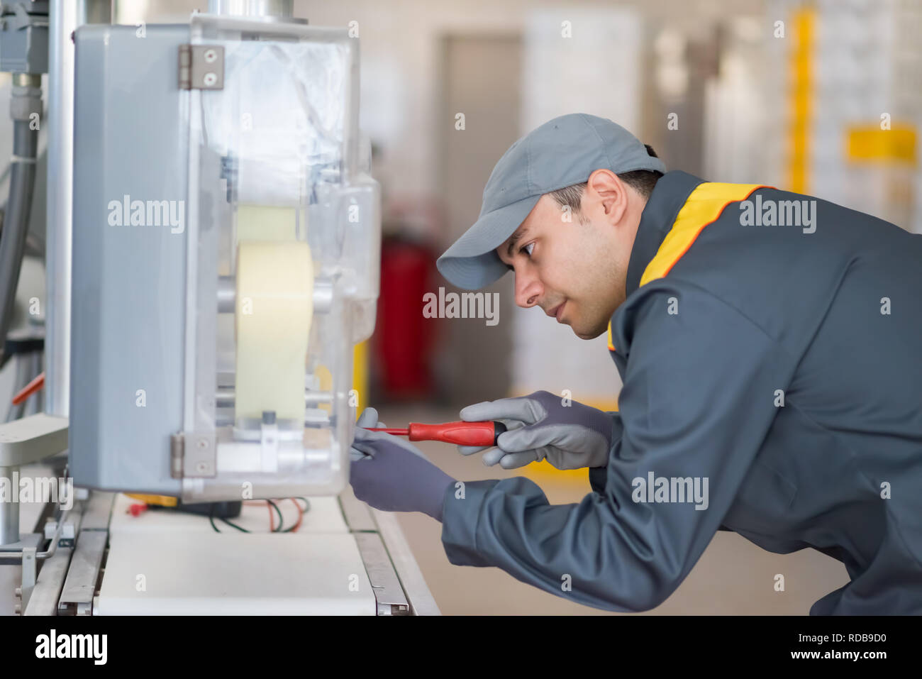 Mechanic electrician fixing a machinery in an industrial factory Stock Photo Alamy