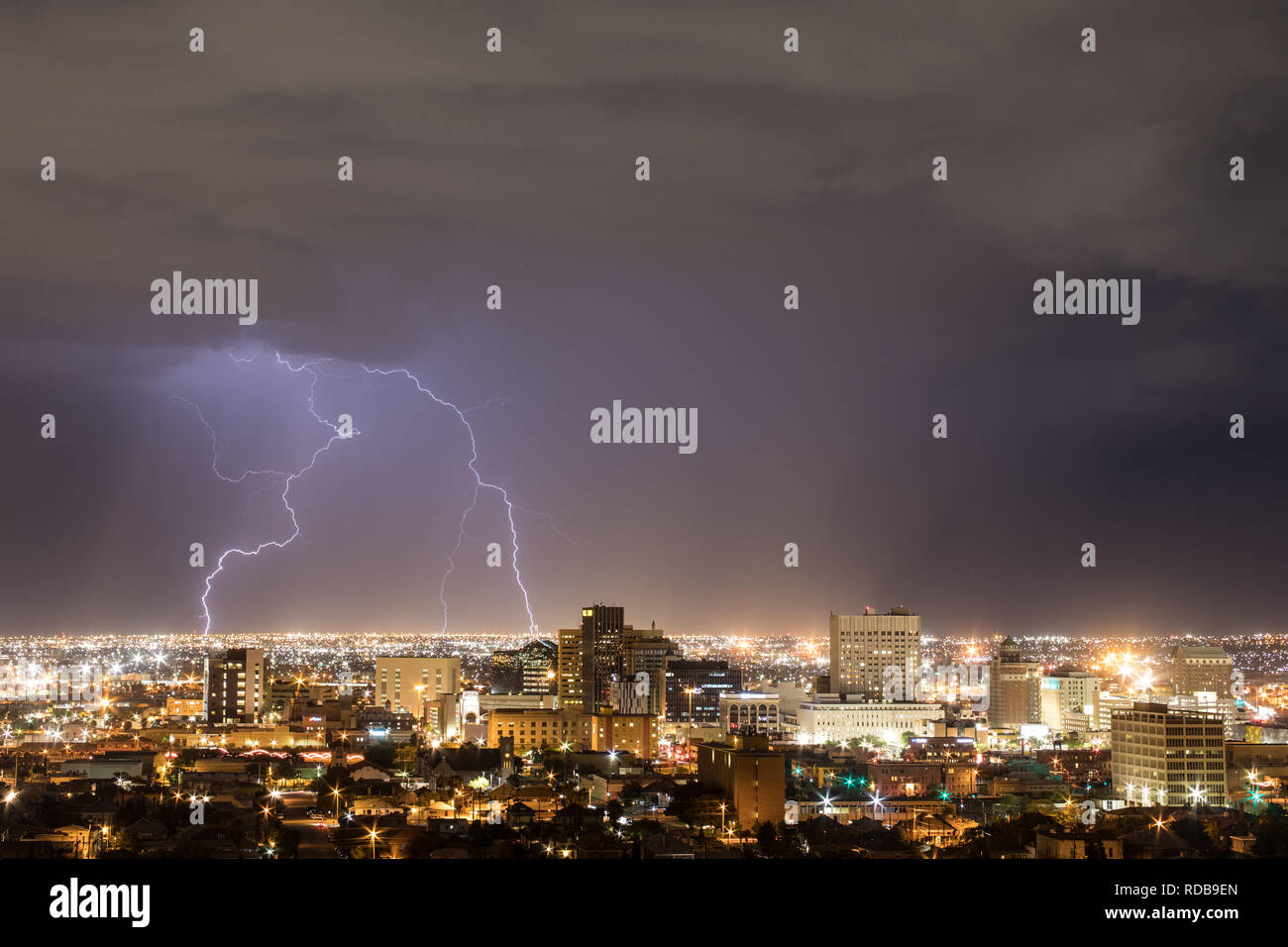 Two lightning bolts strike to the left of the El Paso, Texas skyline