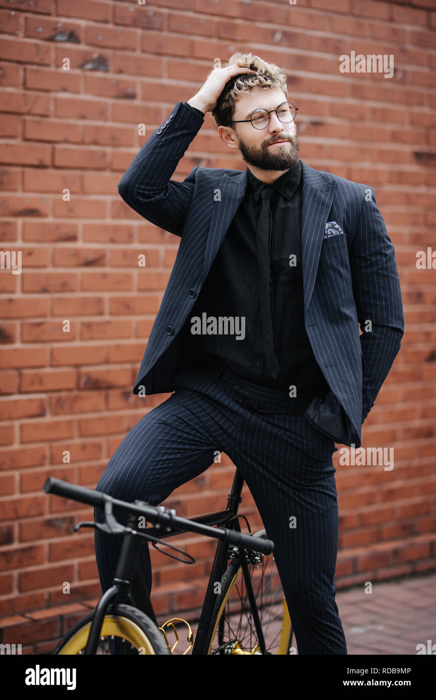 Stylish Businessman Standing With His Bicycle Against Brick Wall Stock 