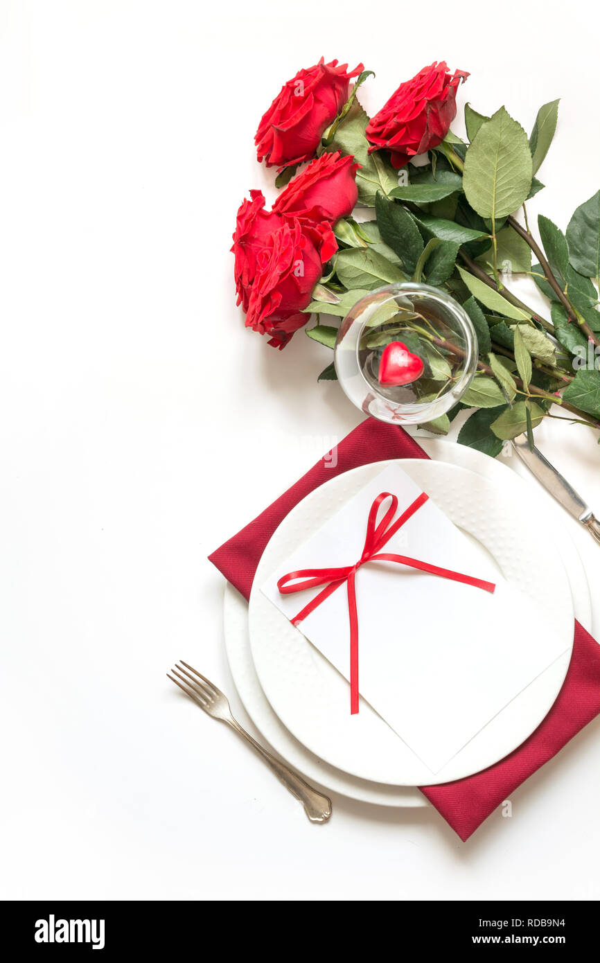 Valentine's day dinner. Romantic table setting with red roses. Top view ...