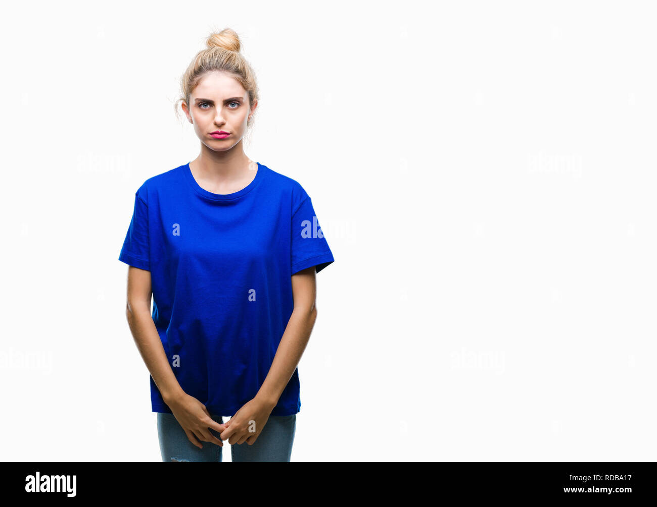 Young beautiful blonde and blue eyes woman wearing blue t-shirt over isolated background skeptic and nervous, frowning upset because of problem. Negat Stock Photo