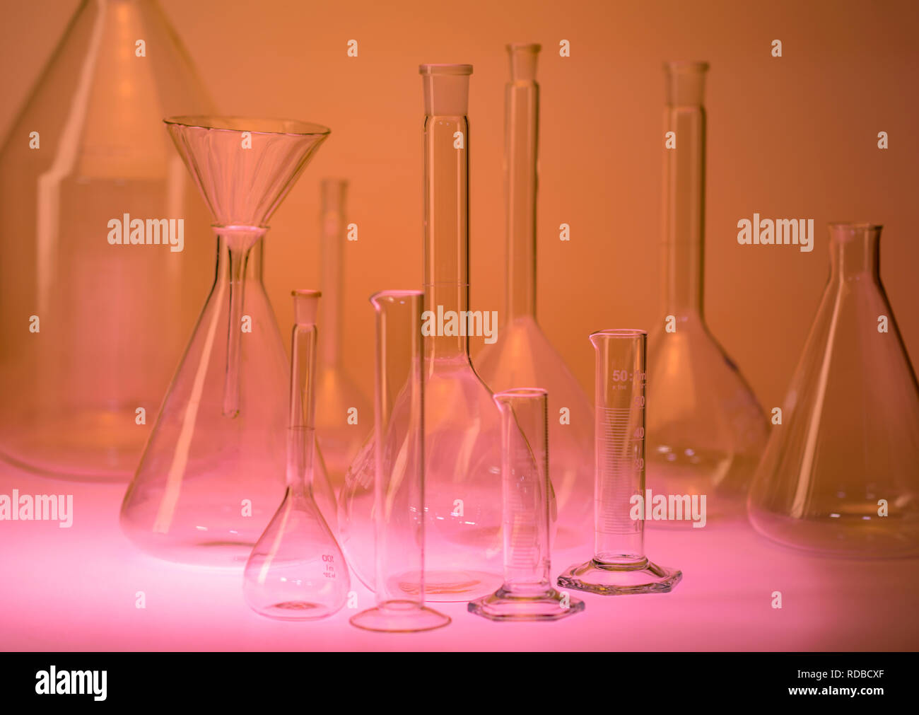 variety of laboratory glassware in warm illuminated ambiance Stock