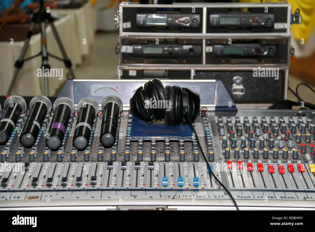 Close up of wireless microphone and headphone put on sound music mixer