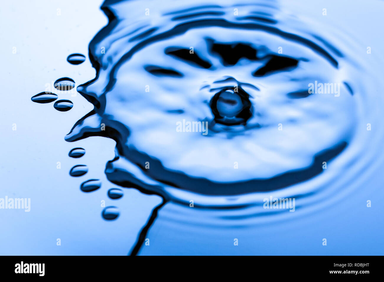 Blue water droplets on a shiny surface Stock Photo