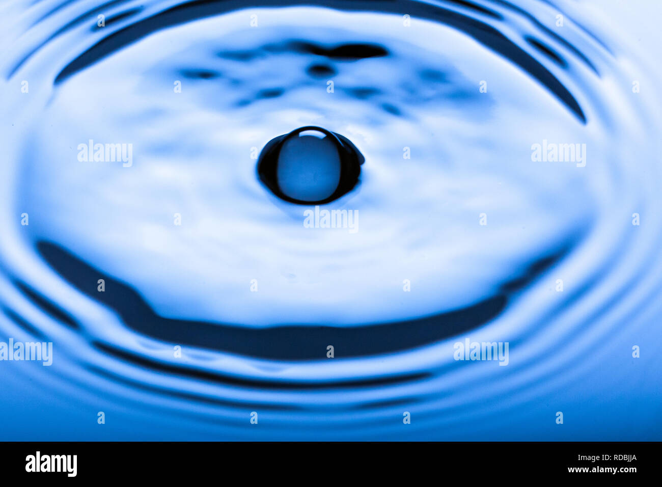 Blue water droplets on a shiny surface Stock Photo