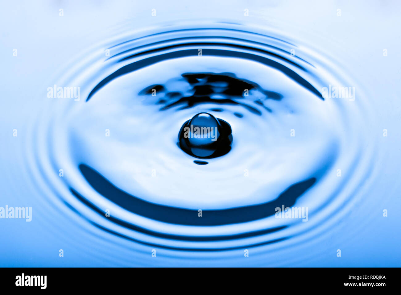 Blue water droplets on a shiny surface Stock Photo