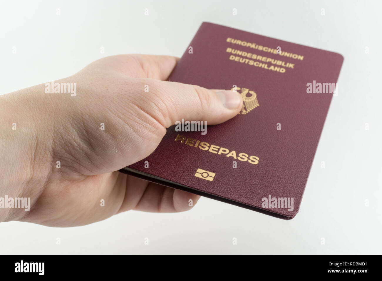 hand holding or giving a german passport document - white background Stock Photo