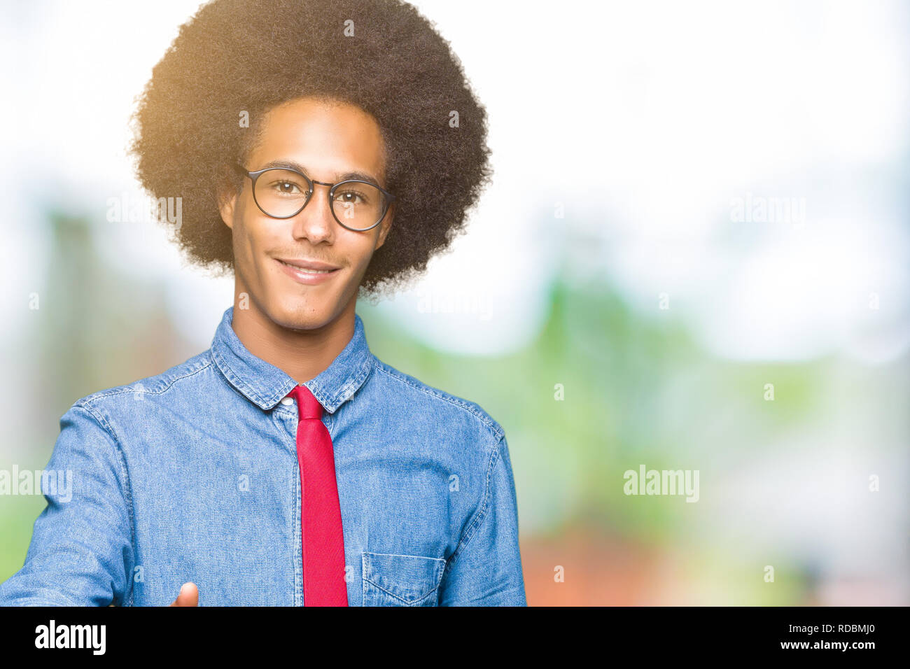 Young african american business man with afro hair wearing glasses and ...