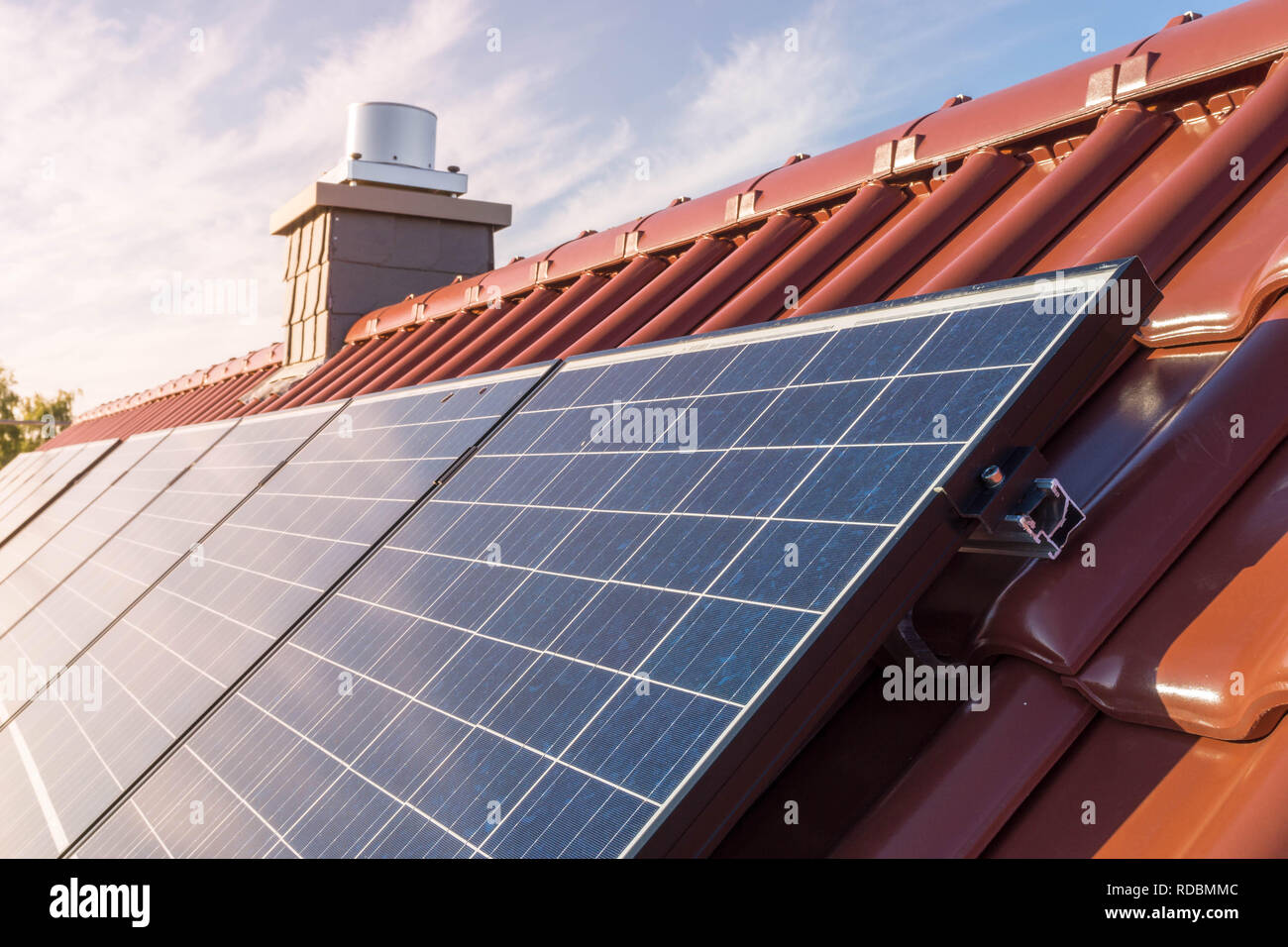 solar panels or photovoltaic power plant on a red tiled roof Stock Photo