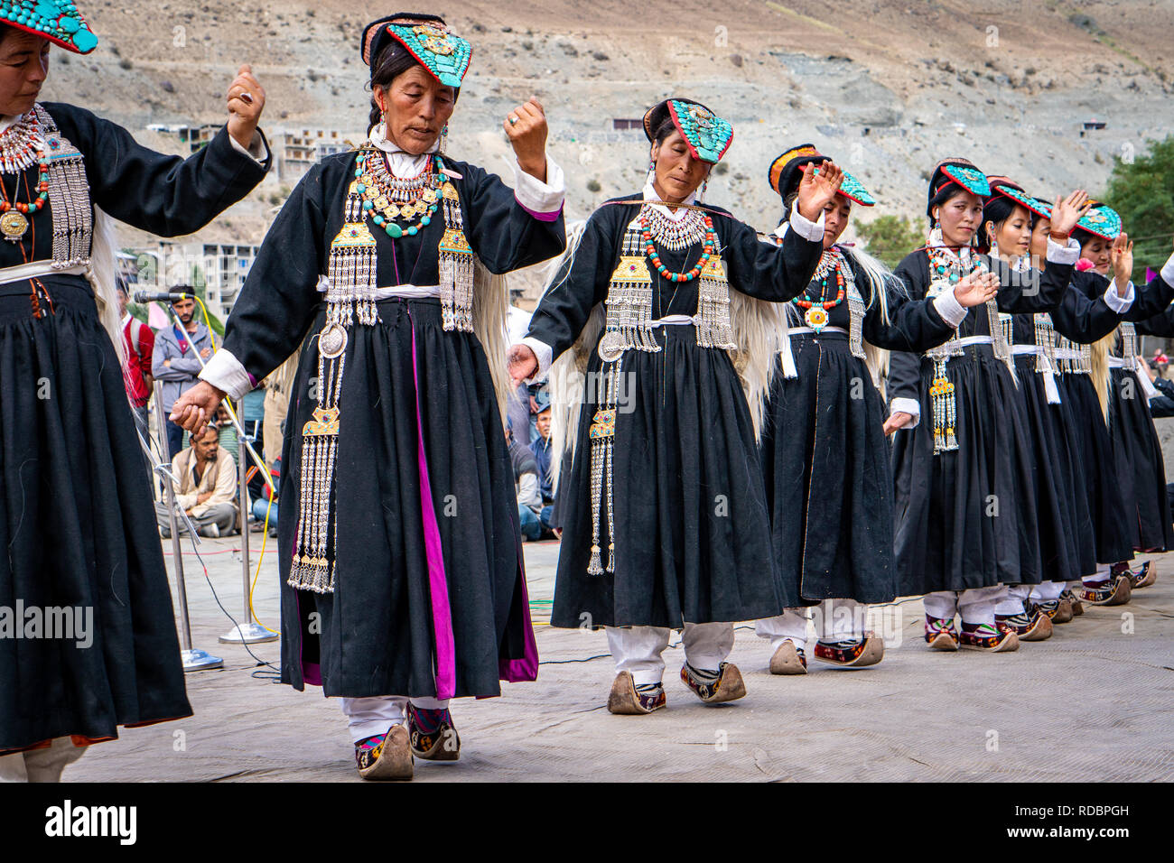 Ladakh, India - September 4, 2018: Group of dancers in traditional clothes performing on festival in Ladakh. Illustrative editorial. Stock Photo