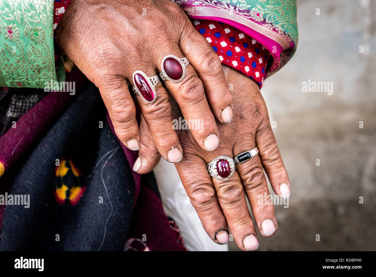 Close up on hands of elderly ethnic Indian woman with large rings on her fingers. Stock Photo