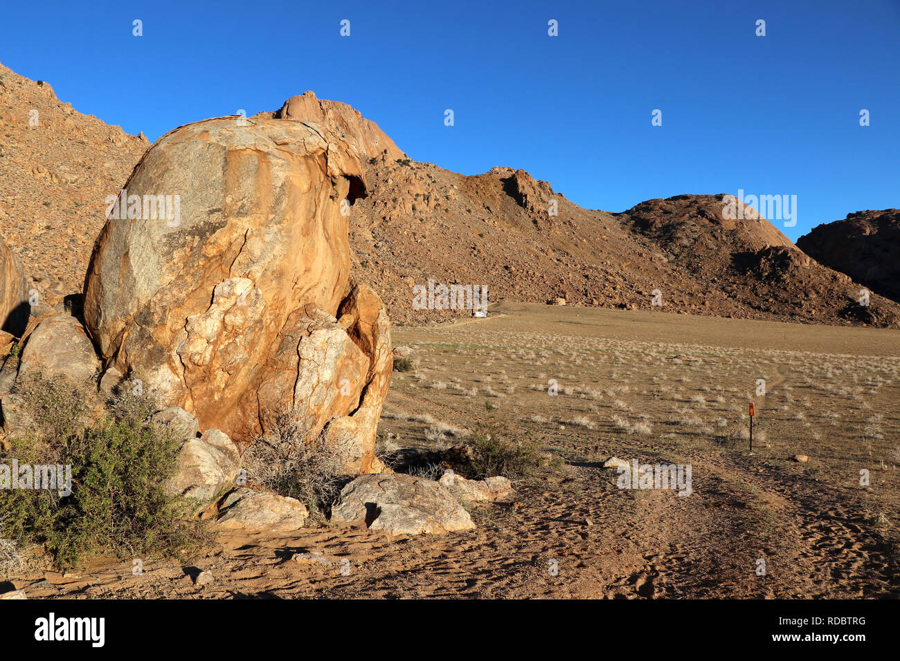 Rock with a view of the desert (eagle nest) and the mountains of Namibia Stock Photo