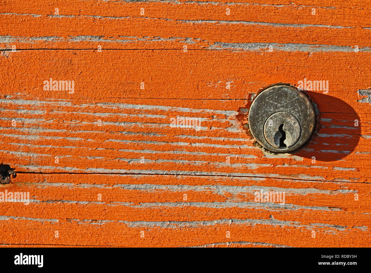 rusty lock and peeling paint on a beach cabin with distressed wood grain in winter in Italy on the Adriatic coast Stock Photo