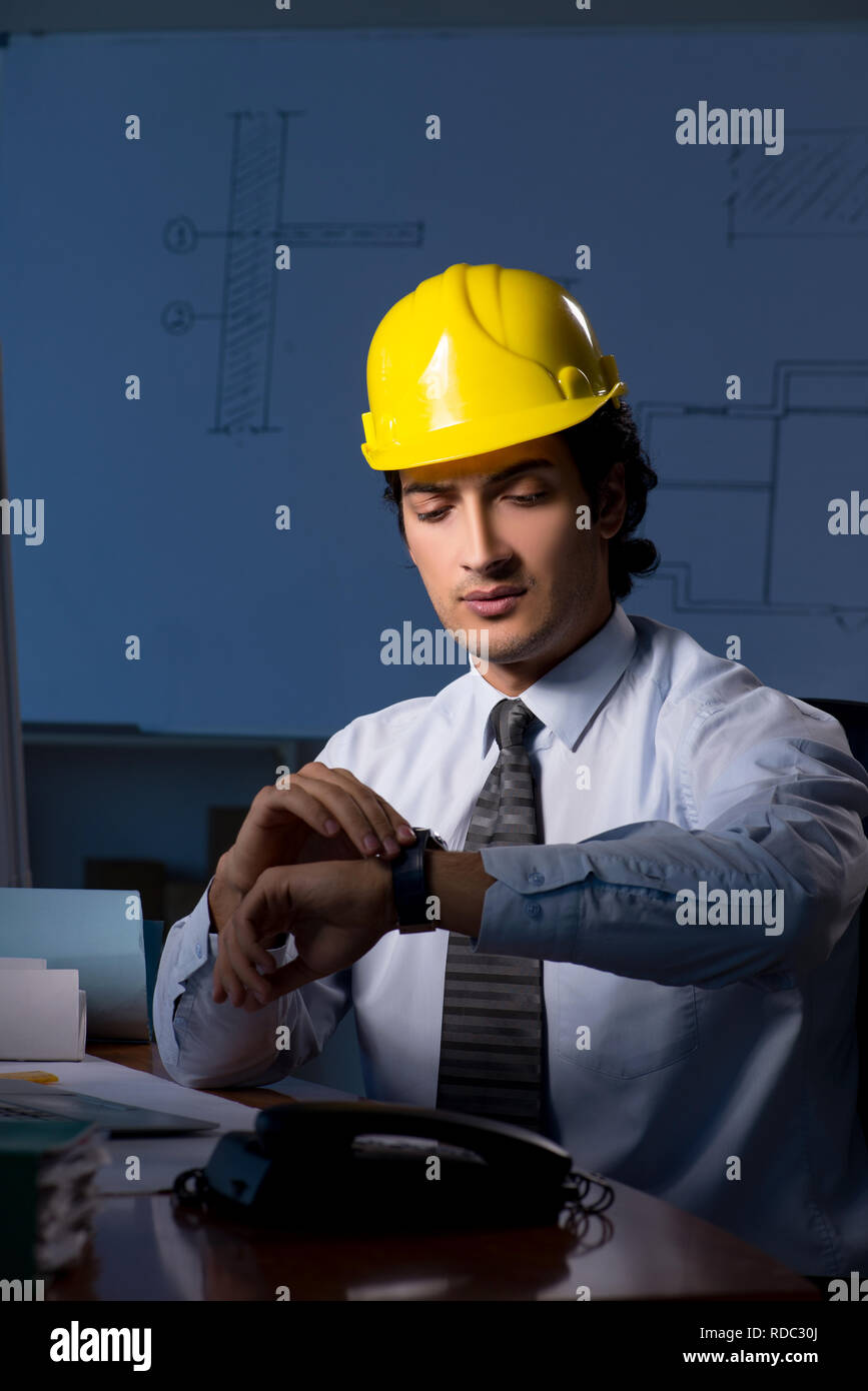 Young construction architect working on project at night Stock Photo