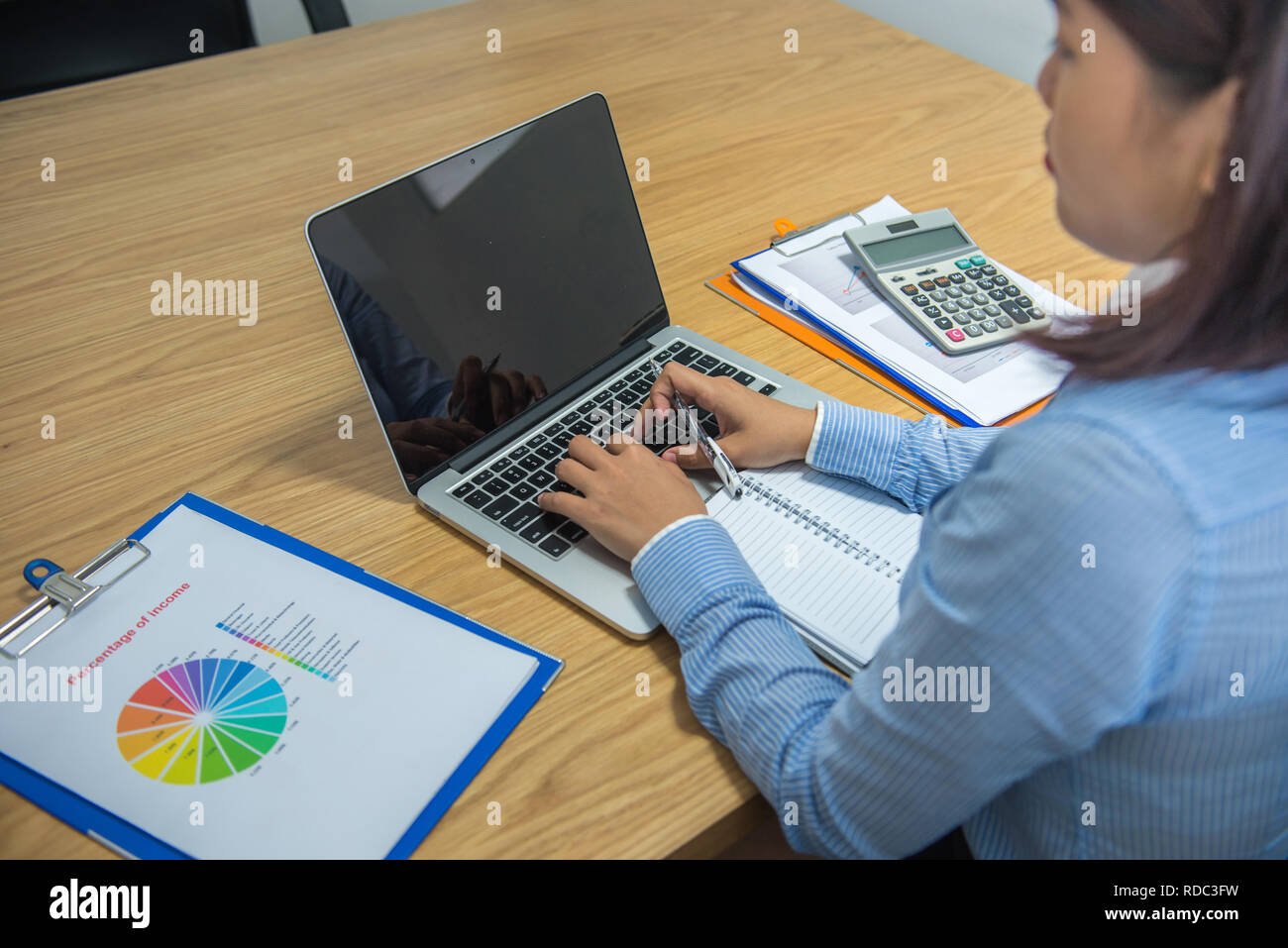 Office lady working on laptop Stock Photo