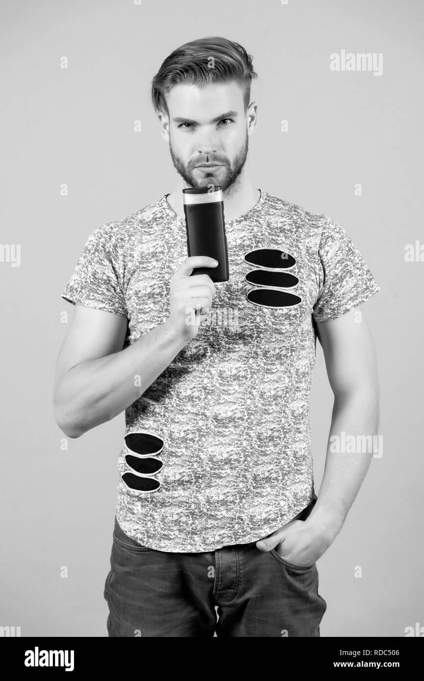 ideal shampoo. Man with gel or shampoo bottle in hand. Hygiene, grooming, beauty. Barber