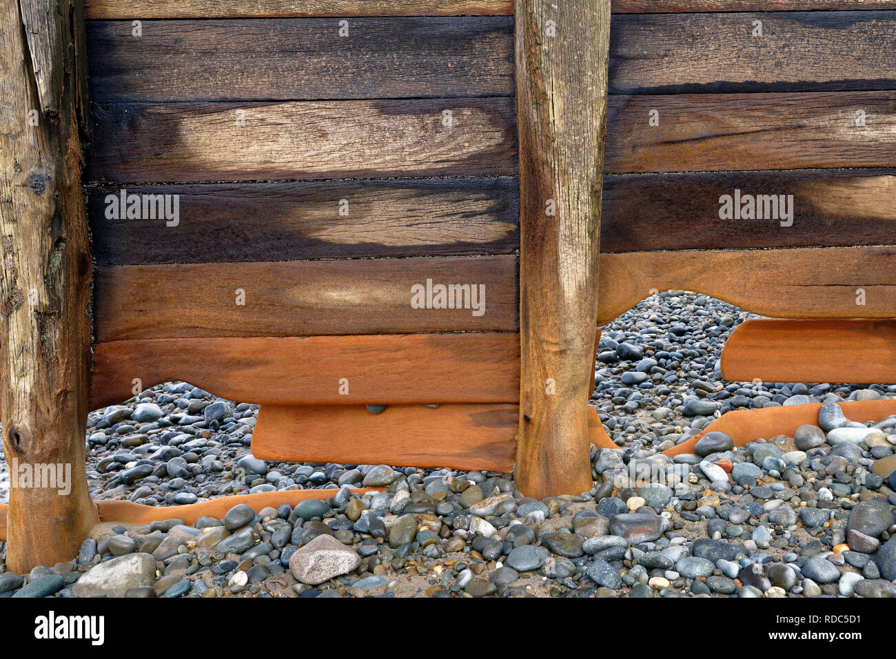 A close up of a section of weathered groyne on Barmouth Beach, Wales. Stock Photo