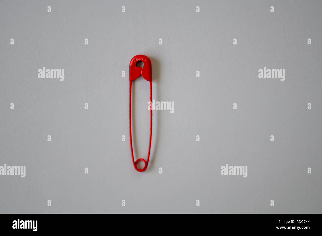 One red safety pin isolated on white background, close up Stock Photo