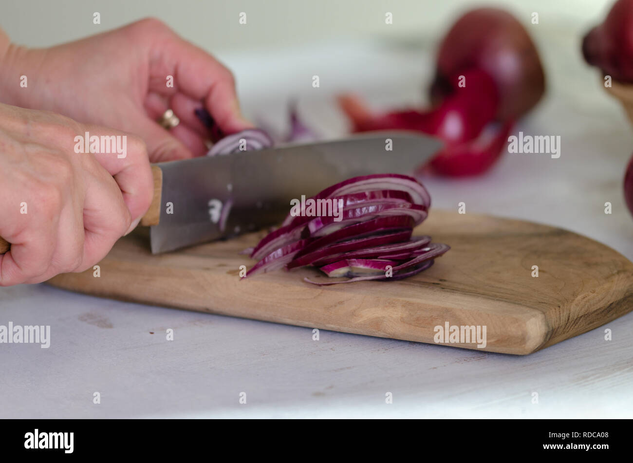 Woman cut onion knife hi-res stock photography and images - Alamy