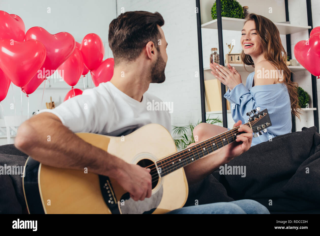 happy couple celebrating st valentine day while young man playing ...