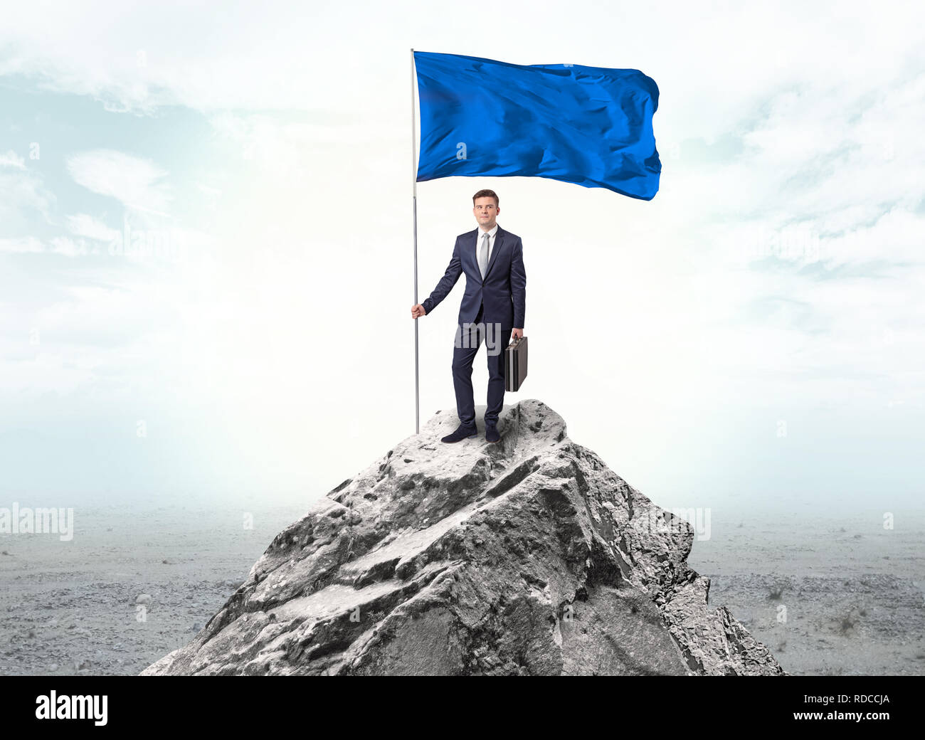Handsome businessman on the top of the mountain with blue flag Stock ...