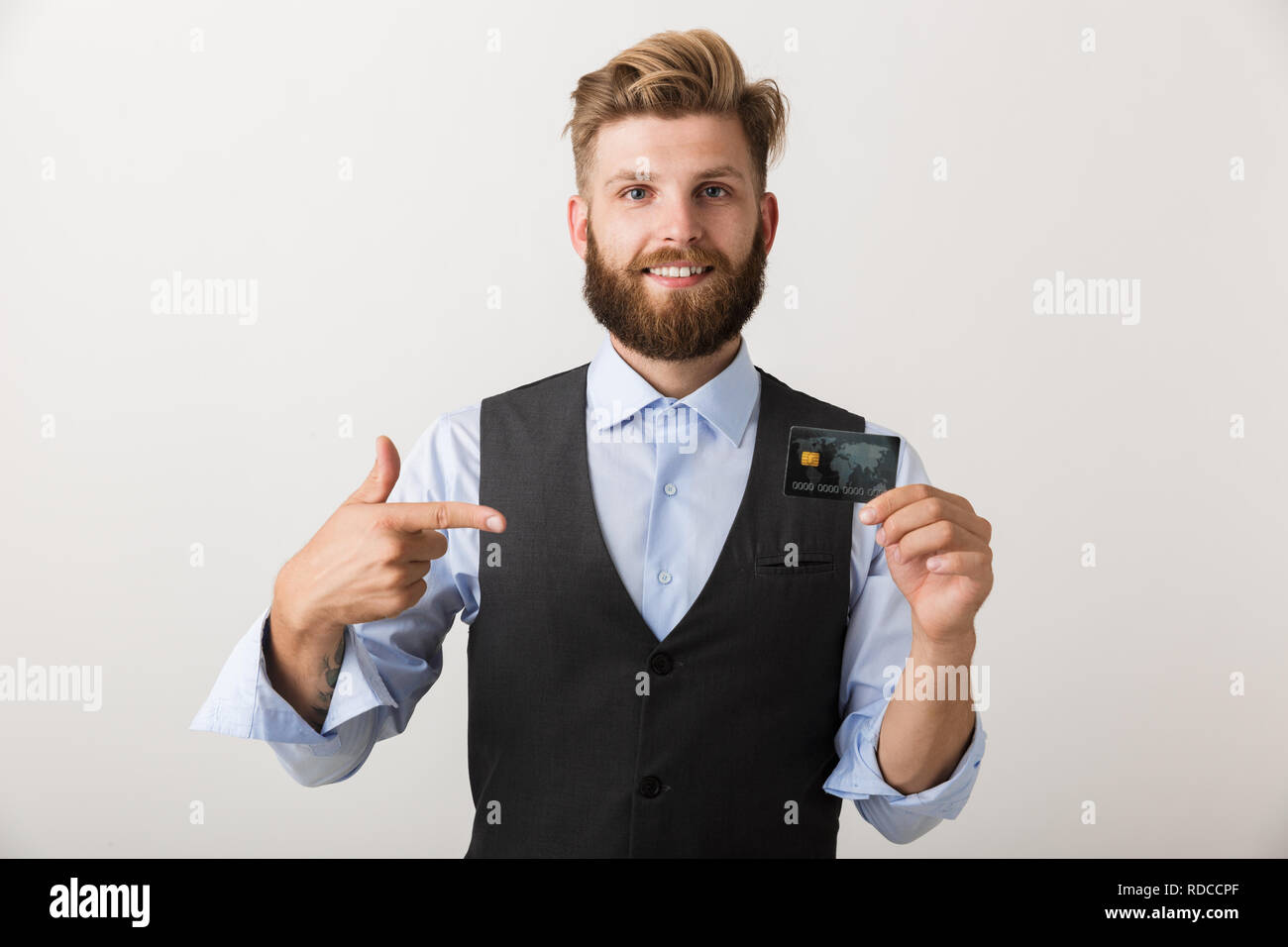 Confident young business man standing isolated over white background ...