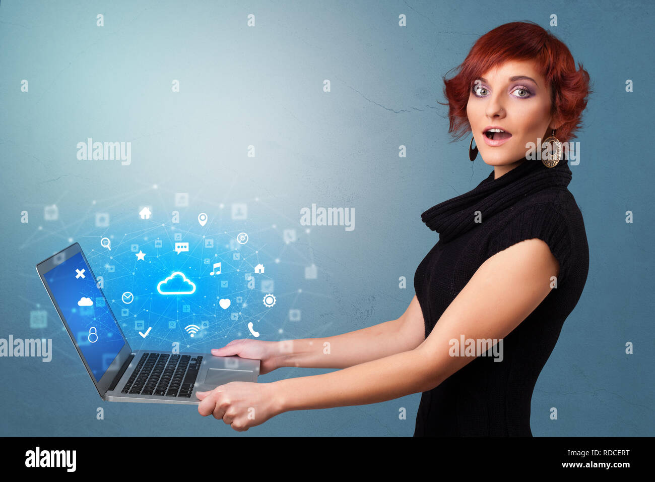 Woman holding laptop projecting notifications, symbols and information