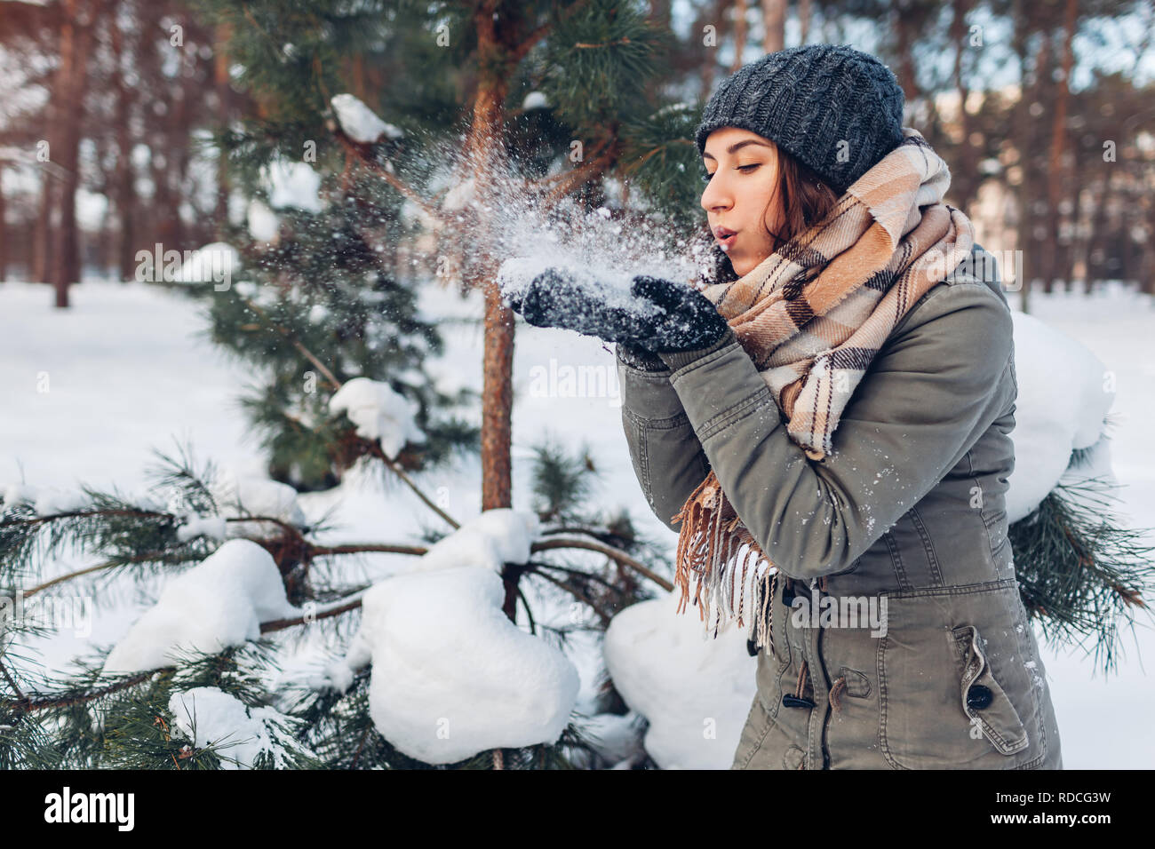 Young woman blowing snow in winter forest. Girl having fun outdoors. Winter  activities Stock Photo - Alamy