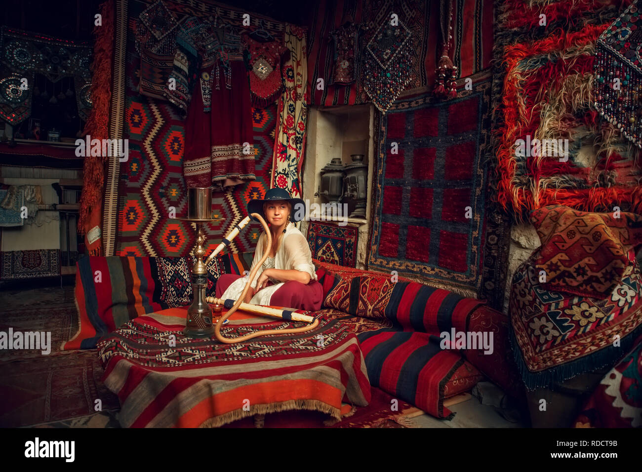 Girl in old carpet shop in Cappadocia, Goreme, Turkey. Stock Photo