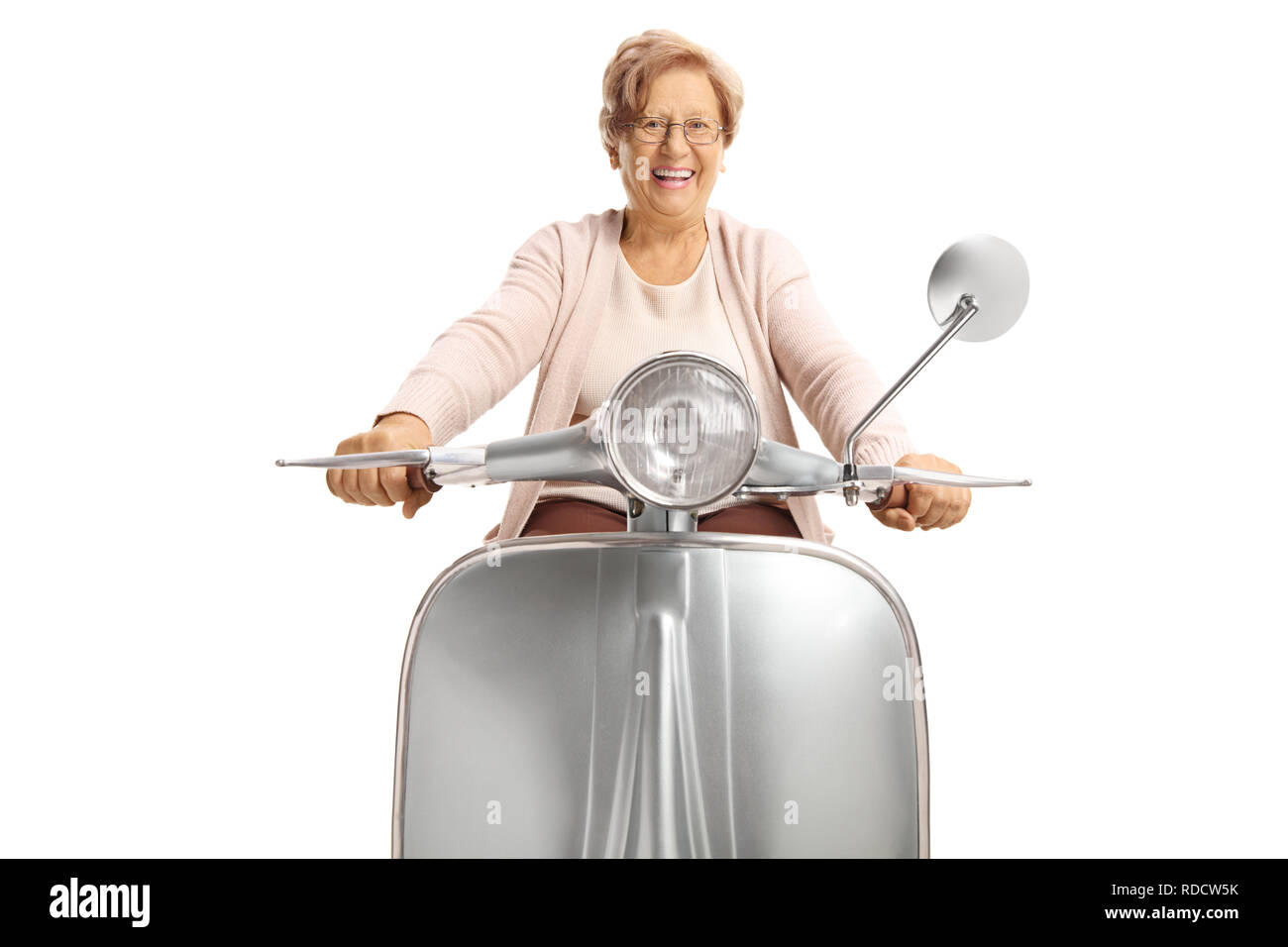 Cheerful senior woman riding a vintage scooter isolated on white background Stock Photo