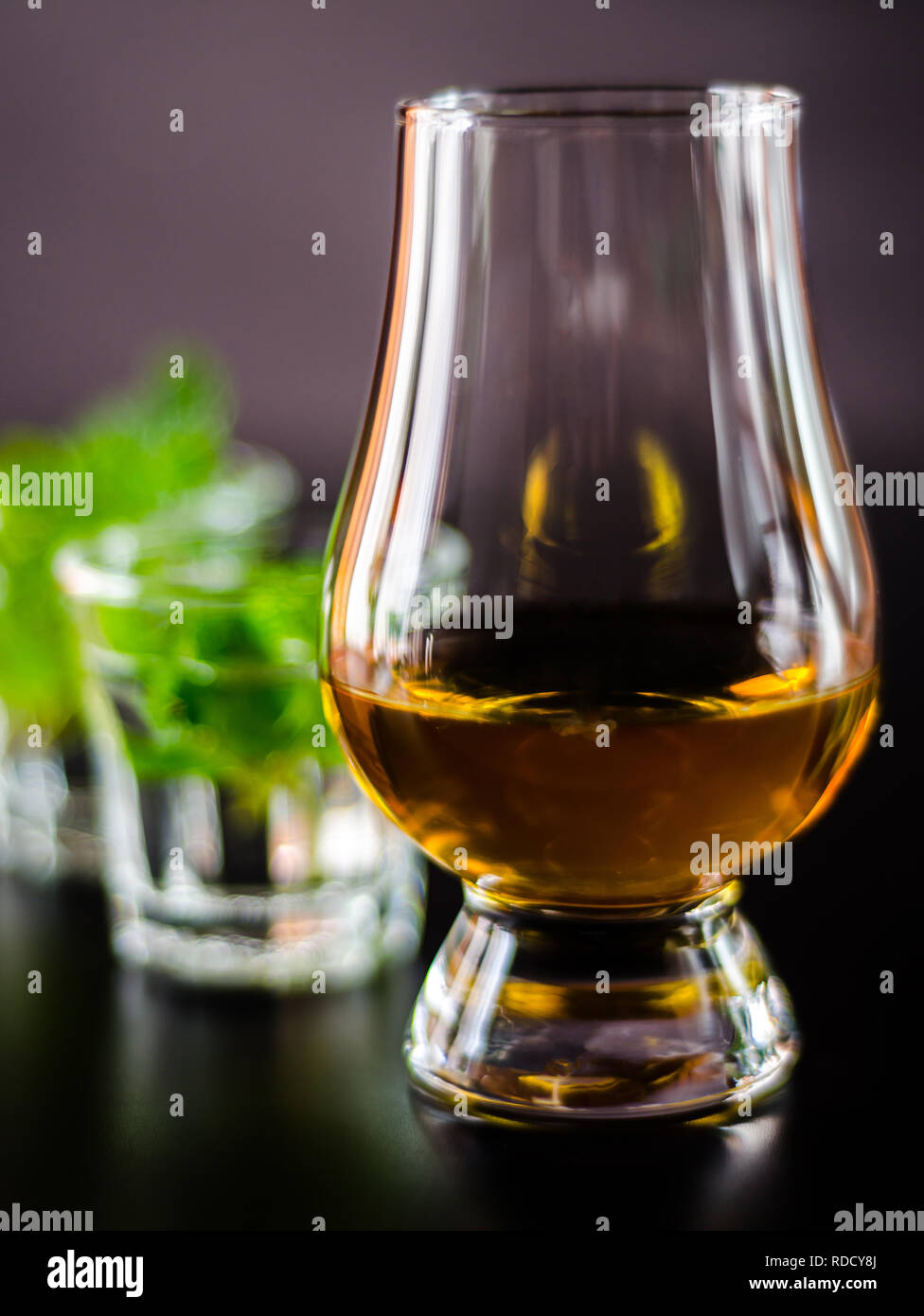 single malt whiskey in a glass and green mint liqueur, refreshing set