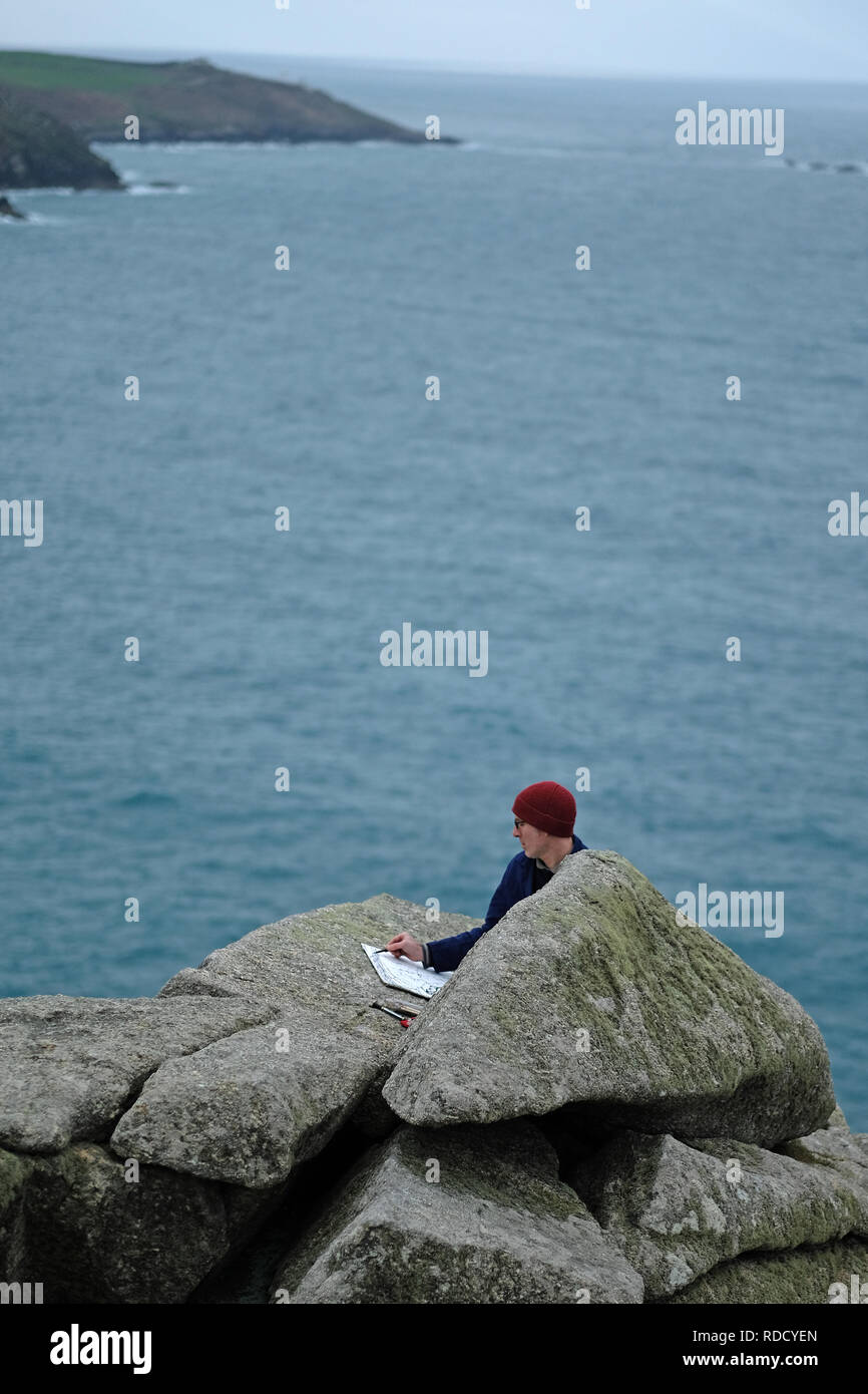 A landscape painter sketching in Cornwall,UK Stock Photo