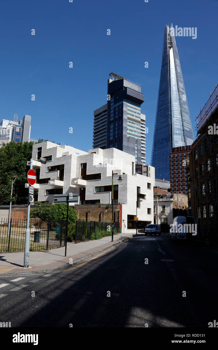 Modern housing scheme on Weston Street in front of Guy's Hospital and the Shard, Bermondsey, London, UK Stock Photo