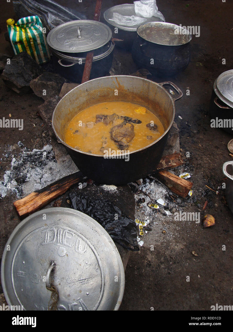 Limbe, Cameroon - November 2009: A big pot of stew cooking on open fire in Cameroon, Africa. Stock Photo