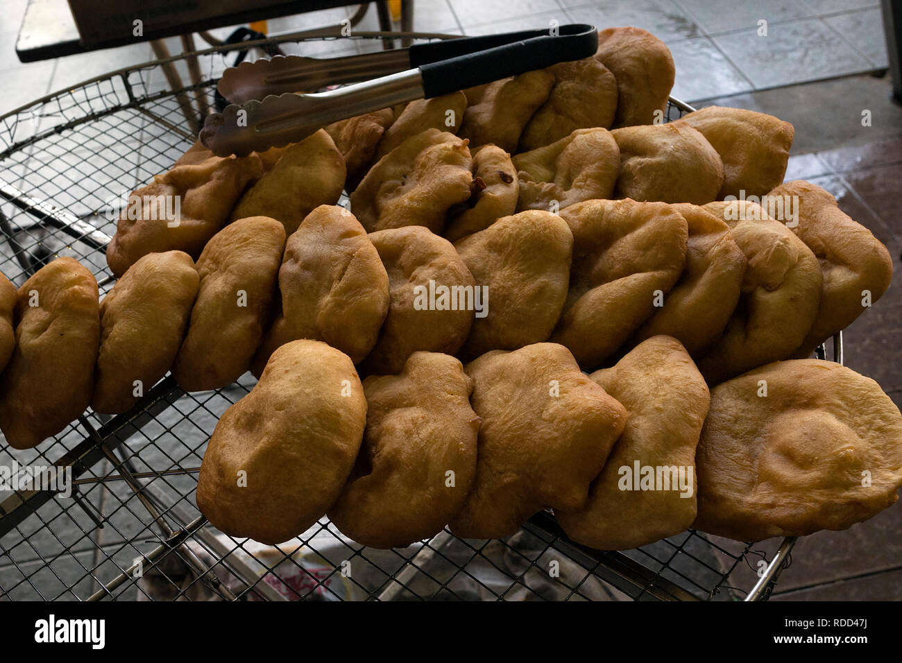 Fried bread bun, or known as Ham Chim Peng, popular food in Malaysia and Singapore - Crispy Ham chim pengs getting up from hot oil Stock Photo