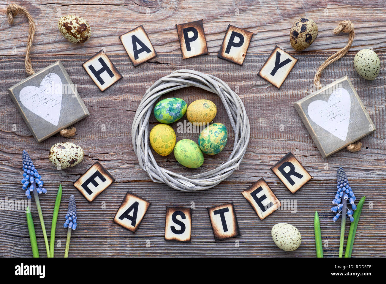 Happy Easter lettering text on rustic wood with blue hyacinth flowers ...